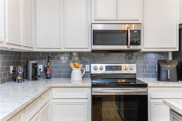 kitchen with white cabinetry and appliances with stainless steel finishes