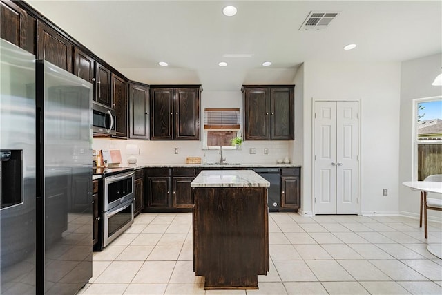 5921 Tapestry Dr, Corpus Christi, TX 78414 - kitchen with stainless steel appliances, tasteful backsplash, light tile patterned flooring, a kitchen island, and recessed lighting