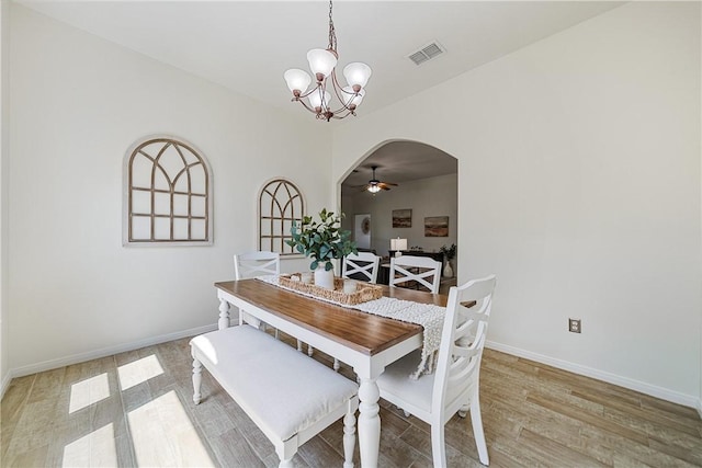 5921 Tapestry Dr, Corpus Christi, TX 78414 - dining area featuring a ceiling fan, a chandelier, arched walkways, and light wood-style floors