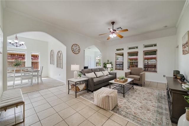 5921 Tapestry Dr, Corpus Christi, TX 78414 - living room featuring light tile patterned flooring, arched walkways, healthy amount of natural light, and ornamental molding