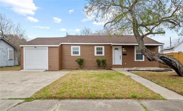 ranch-style house with a garage and a front lawn