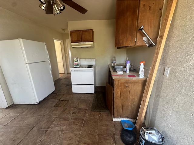 kitchen with sink, white appliances, and ceiling fan