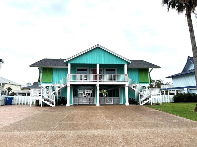 22 Whooping Crane Ln, Rockport, TX 78382 - view of front of property featuring stairs, covered porch, and a shingled roof