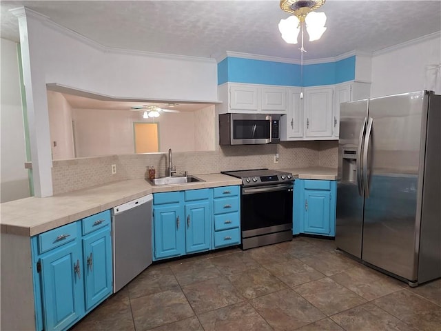 325 S Saunders St S, Aransas Pass, TX 78336 - kitchen with appliances with stainless steel finishes, a sink, a ceiling fan, decorative backsplash, and blue cabinets