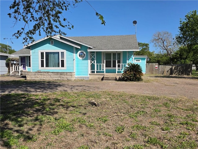 325 S Saunders St S, Aransas Pass, TX 78336 - view of front of property with a shingled roof and fence