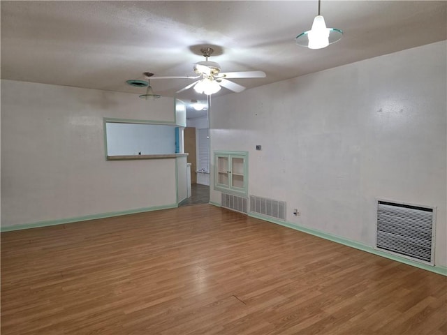 325 S Saunders St S, Aransas Pass, TX 78336 - unfurnished room with a ceiling fan, wood finished floors, and visible vents