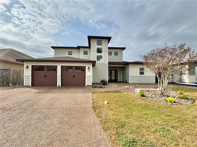 prairie-style home with a garage and a front lawn