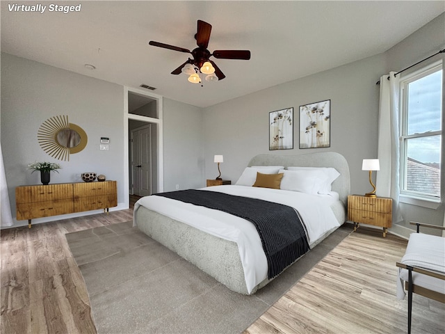 bedroom with ceiling fan and hardwood / wood-style flooring