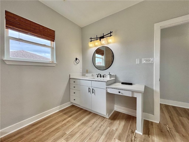 bathroom with hardwood / wood-style floors and vanity