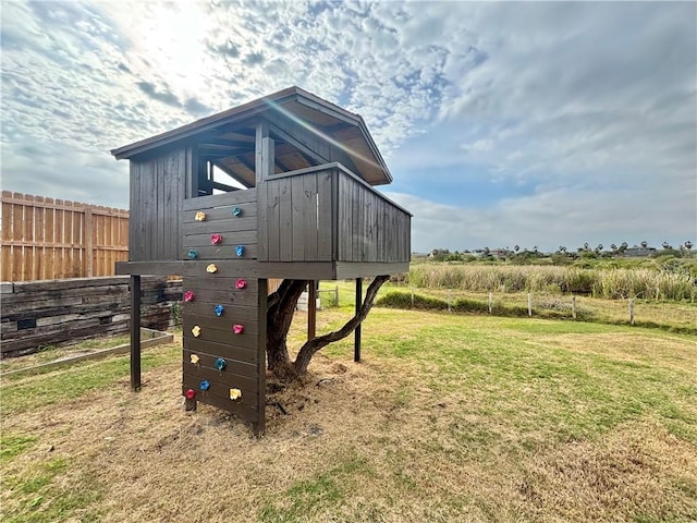 view of play area featuring a yard and a rural view