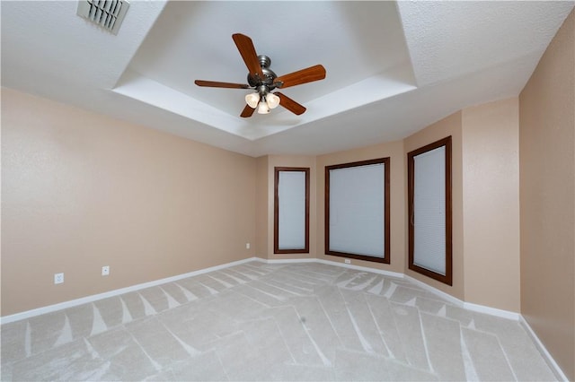 8018 Mt Zion, Corpus Christi, TX 78413 - empty room with a tray ceiling, ceiling fan, baseboards, and light carpet