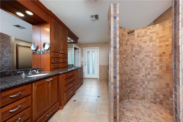 8018 Mt Zion, Corpus Christi, TX 78413 - bathroom featuring tile walls, a tile shower, tile patterned flooring, and vanity