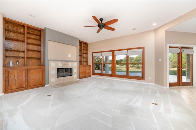 8018 Mt Zion, Corpus Christi, TX 78413 - unfurnished living room with built in features, light colored carpet, baseboards, ceiling fan, and a tile fireplace