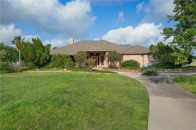 8018 Mt Zion, Corpus Christi, TX 78413 - view of front of property featuring a front lawn, a chimney, and brick siding