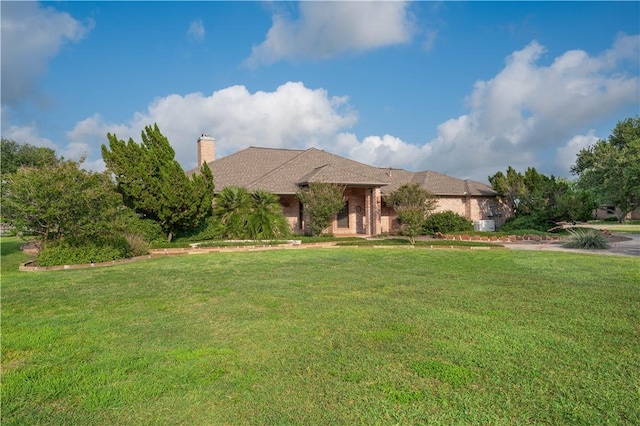 8018 Mt Zion, Corpus Christi, TX 78413 - view of front facade with a front yard and a chimney