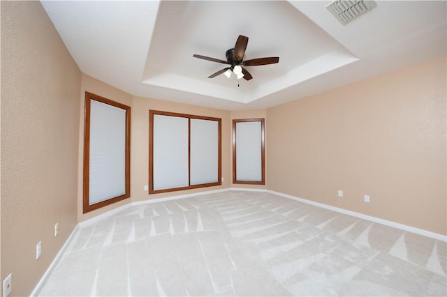 8018 Mt Zion, Corpus Christi, TX 78413 - empty room with ceiling fan, a tray ceiling, light colored carpet, and baseboards