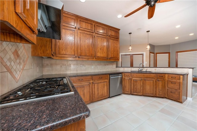 8018 Mt Zion, Corpus Christi, TX 78413 - kitchen featuring appliances with stainless steel finishes, a sink, brown cabinets, a peninsula, and a ceiling fan