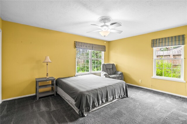 4410 Marie St, Corpus Christi, TX 78411 - carpeted bedroom with baseboards, ceiling fan, and a textured ceiling