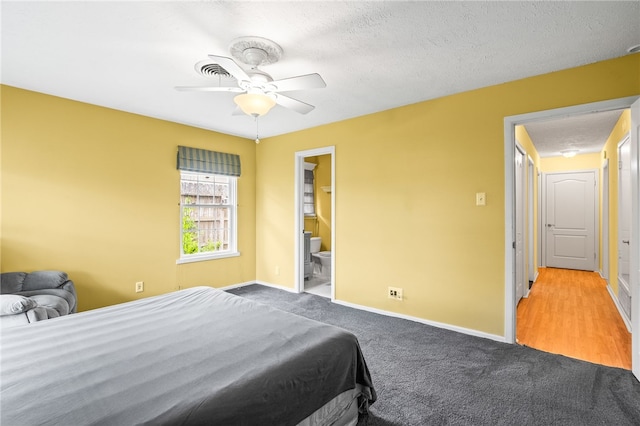 4410 Marie St, Corpus Christi, TX 78411 - bedroom with carpet floors, baseboards, a ceiling fan, connected bathroom, and a textured ceiling
