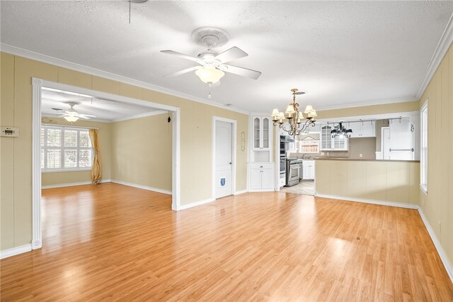 4410 Marie St, Corpus Christi, TX 78411 - unfurnished living room featuring light wood-style flooring, a chandelier, a textured ceiling, ceiling fan, and crown molding