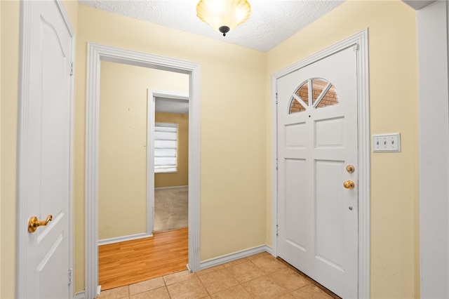 4410 Marie St, Corpus Christi, TX 78411 - foyer entrance with a textured ceiling, baseboards, and light tile patterned floors