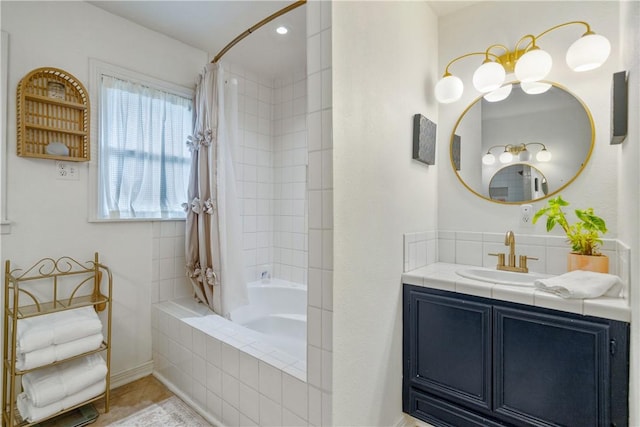 bathroom featuring vanity and tiled shower / bath