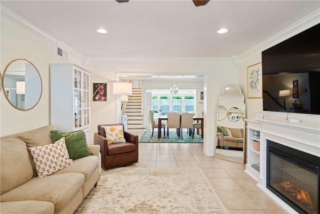 living area featuring stairs, ornamental molding, visible vents, a notable chandelier, and light tile patterned flooring