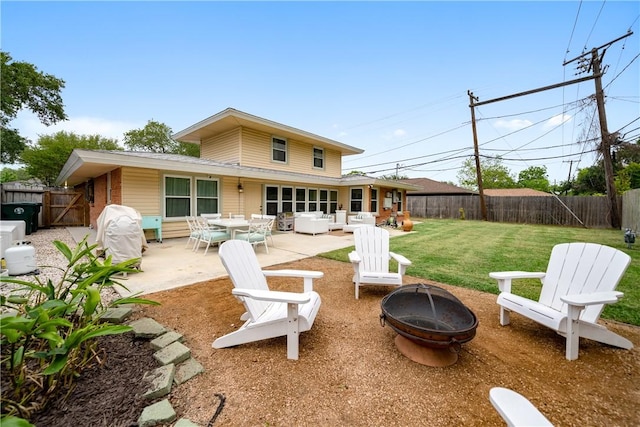 rear view of property with an outdoor living space with a fire pit, a gate, a patio area, a yard, and a fenced backyard