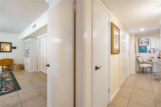 corridor with baseboards, recessed lighting, light tile patterned floors, and ornamental molding