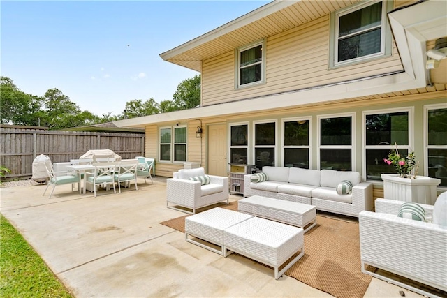 view of patio with fence, outdoor dining space, and an outdoor hangout area