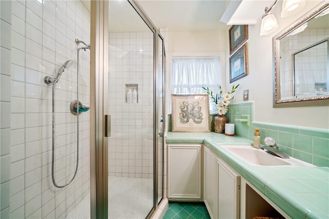 bathroom with tile patterned floors, a stall shower, and vanity