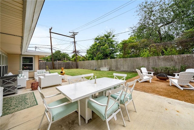 view of patio featuring an outdoor living space with a fire pit, outdoor dining space, and a fenced backyard