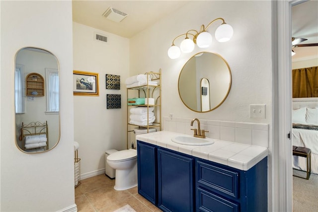 ensuite bathroom featuring vanity, visible vents, toilet, and ensuite bathroom