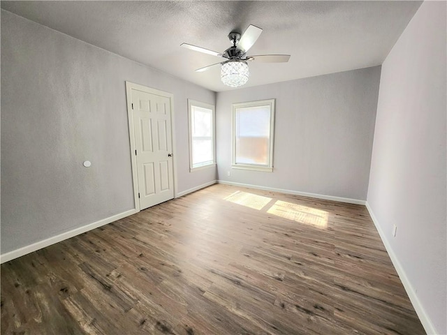 unfurnished room featuring ceiling fan, hardwood / wood-style floors, and a textured ceiling