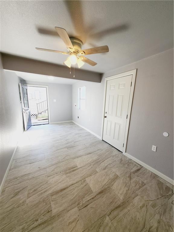 spare room with ceiling fan