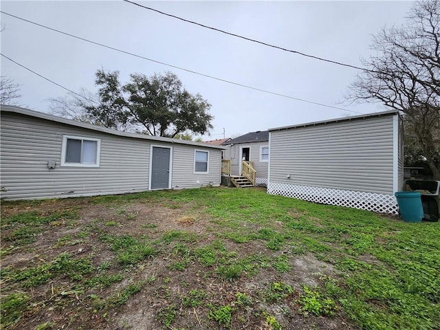 back of house with a lawn