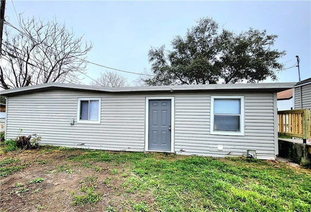 rear view of house with a yard