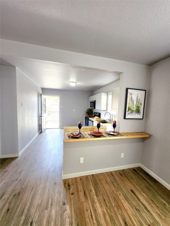 empty room with ceiling fan and hardwood / wood-style floors