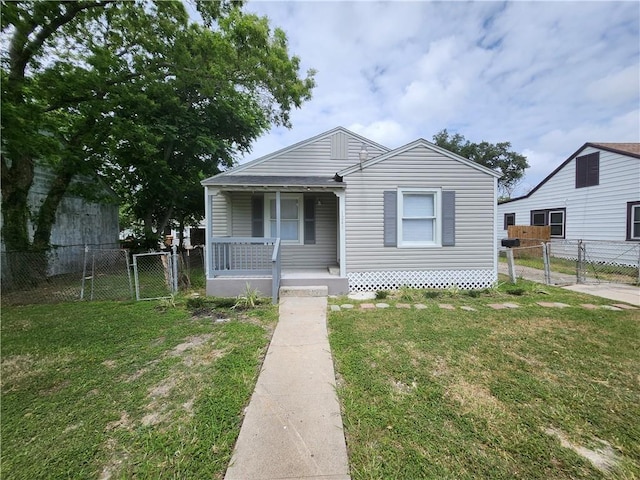 bungalow with a front yard and a porch