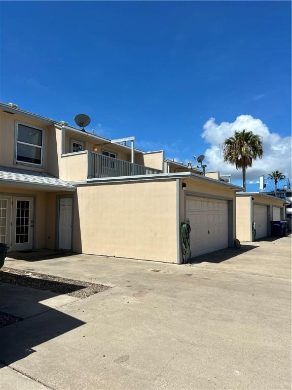 view of property exterior with a balcony and stucco siding