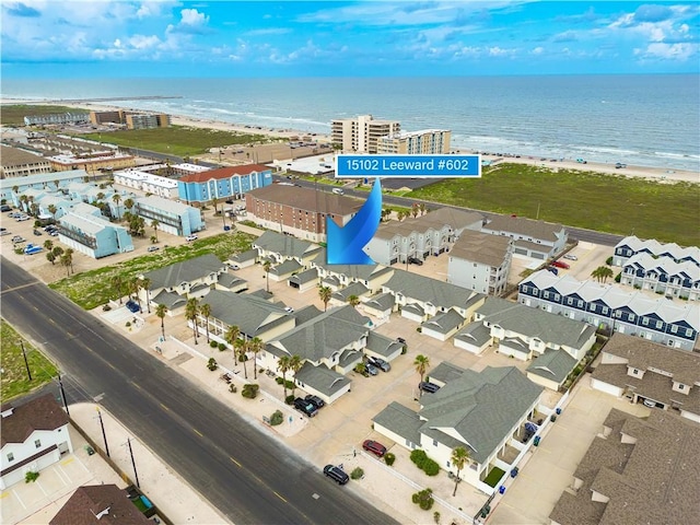 drone / aerial view featuring a water view and a view of the beach