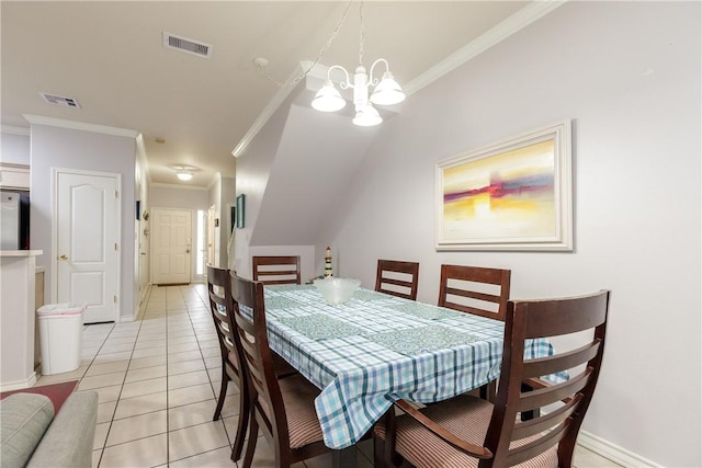 tiled dining area featuring ornamental molding and a notable chandelier