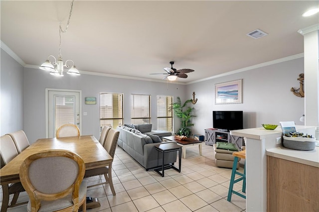 tiled dining room with ceiling fan with notable chandelier and ornamental molding