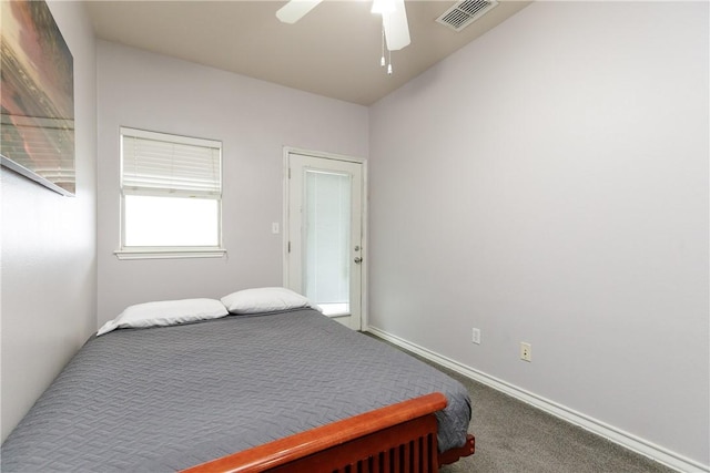 bedroom featuring ceiling fan and carpet