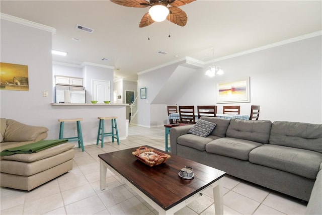 tiled living room with ceiling fan with notable chandelier and crown molding