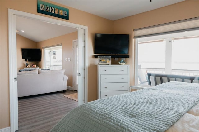 299 Bay Dr, Palacios, TX 77465 - bedroom featuring wood finished floors, baseboards, and vaulted ceiling