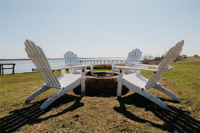 299 Bay Dr, Palacios, TX 77465 - view of property's community with a fire pit, a lawn, and a water view