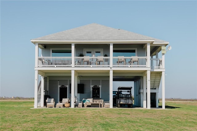 299 Bay Dr, Palacios, TX 77465 - rear view of property with a yard, an outdoor hangout area, a balcony, and roof with shingles