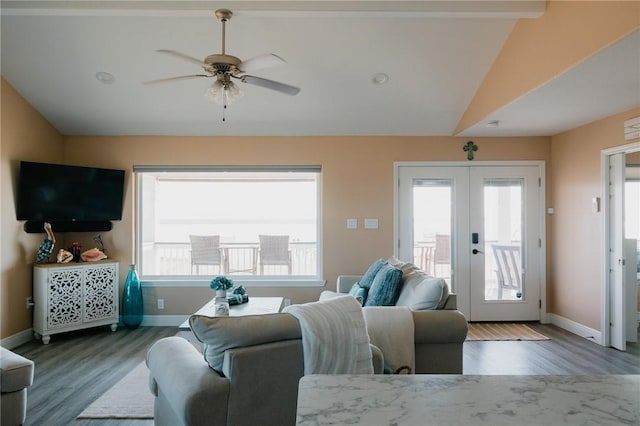 299 Bay Dr, Palacios, TX 77465 - living area with french doors, wood finished floors, a ceiling fan, baseboards, and vaulted ceiling