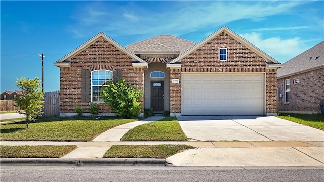 ranch-style house featuring brick siding, an attached garage, a front lawn, and concrete driveway